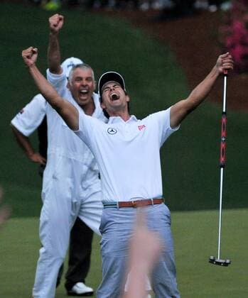 Adam Scott, caddie Steve Williams and Angel Cabrera react when Scott sinks a birdie putt on the second hole of a sudden-death playoff in the fourth round of the Masters at Augusta National on April 14, 2013 in Augusta, Georgia. Adam Scott defeated Angel Cabrera on the second playoff hole to become the first Australian to win a Green Jacket.  AUG20130414576