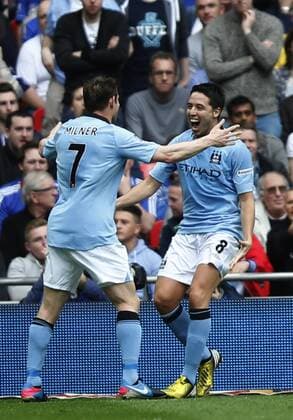 (130414) -- LONDON, April 14, 2013 (Xinhua) -- Samir Nasri (R) of Manchester City celebrates scoring with his teammate James Milner during FA Cup semifinal between Manchester City and Chelsea at Wembley Stadium in London, Britain, on April 14, 2013. Manchester City won 2-1 and will meet Wigan Athletic in the FA Cup final. (Xinhua Wang Lili) (zf) , -FA CUP-SEMIFINAL-MAN CITY VS CHELSEA 