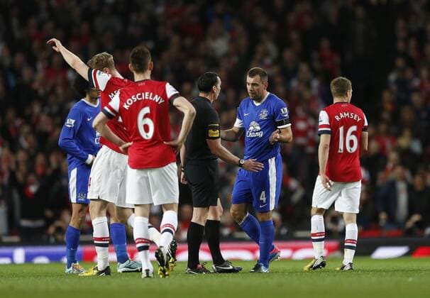 Everton s Darron Gibson who was already booked is not given another card by referee Neil Swarbrick despite body checking Theo Walcott..Arsenal v Everton - Barclays Premier League - Emirates Stadium, London- 16 04 13 - Picture David Klein Sportimage EDITORIAL USE ONLY. No use with unauthorised audio, video, data, fixture lists, club league logos or live services. Online in-match use limited to 120 images, no video emulation. No use in betting, games or single club league player publications.