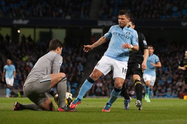Football - 2012 2013 Premier League - Manchester City vs. Wigan Athletic Kun Sergio Aguero of Manchester City goes for a late chance against Joel Robels of Wigan at the Etihad Stadium 