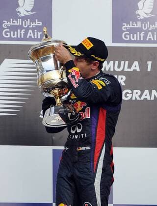 (130421) -- MANAMA, April 21, 2013 (Xinhua) -- Red Bull driver Sebastian Vettel kisses the winner s trophy during the victory ceremony of the Bahrain F1 Grand Prix at the Bahrain International Circuit in Manama, Bahrain, on April 21, 2013. (Xinhua Chen Shaojin) (zf) BAHRAIN-MANAMA-F1 