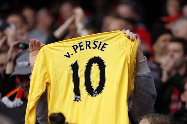 An FC Arsenal fan holds aloft a van Persie shirt - Barclays Premier League - FC Arsenal vs Manchester United (ManU) - Emirates Stadium London - Season 12 13 - 28th April 2013 - EDITORIAL USE ONLY. No use with unauthorised audio, video, data, fixture lists, club league logos or live services. Online in-match use limited to 120 images, no video emulation. No use in betting, games or single club league player publications.