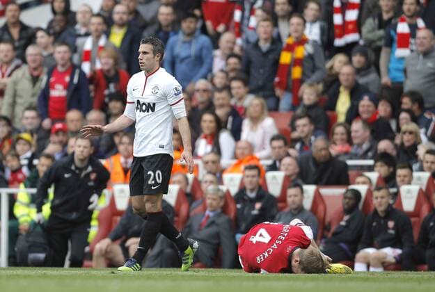 Robin van Persie picks up a yellow card following a foul on Per Mertesacker of FC Arsenal - Barclays Premier League - FC Arsenal vs Manchester United (ManU) - Emirates Stadium London - Season 12 13 - 28th April 2013 - EDITORIAL USE ONLY. No use with unauthorised audio, video, data, fixture lists, club league logos or live services. Online in-match use limited to 120 images, no video emulation. No use in betting, games or single club league player publications.