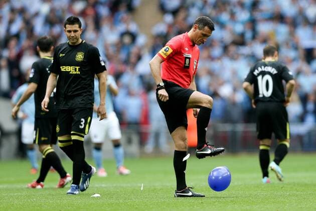 Referee Andre Marriner stamps on a balloon - FA Cup Final - Manchester City vs Wigan Athletic - Wembley Stadium - London - 11 05 2013 - Pic Charlie Forgham-Bailey Sportimage EDITORIAL USE ONLY. No use with unauthorised audio, video, data, fixture lists, club league logos or live services. Online in-match use limited to 120 images, no video emulation. No use in betting, games or single club league player publications.