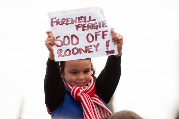 A young fan holds up a sign quoting Farewell Fergie, sod off Rooney! - Manchester United - Premier League Trophy Parade - Manchester - England -13 05 2013 - EDITORIAL USE ONLY. No use with unauthorised audio, video, data, fixture lists, club league logos or live services. Online in-match use limited to 120 images, no video emulation. No use in betting, games or single club league player publications.