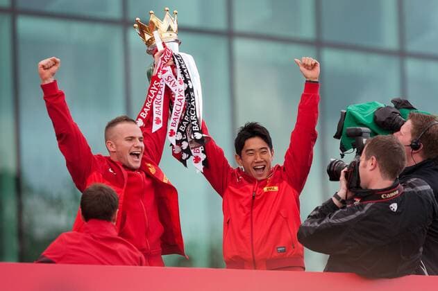 Tom Cleverley and Shinji Kagawa of Manchester United - Manchester United - Premier League Trophy Parade - Manchester - England -13 05 2013 - EDITORIAL USE ONLY. No use with unauthorised audio, video, data, fixture lists, club league logos or live services. Online in-match use limited to 120 images, no video emulation. No use in betting, games or single club league player publications.