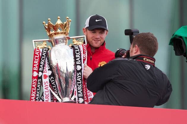 Wayne Rooney of Manchester United poses with the trophy - Manchester United - Premier League Trophy Parade - Manchester - England -13 05 2013 - EDITORIAL USE ONLY. No use with unauthorised audio, video, data, fixture lists, club league logos or live services. Online in-match use limited to 120 images, no video emulation. No use in betting, games or single club league player publications.