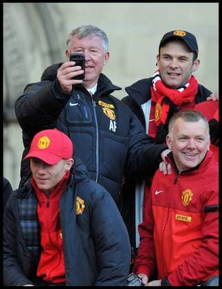 Sir Alex Ferguson takes a picture on his Mobile phone of the fans in Albert Square, Manchester, As Manchester United celebrate winning their 20th league title winning the Premier League, Monday May 13, 2013. AndrewxParsonsx xi-Images  AJP