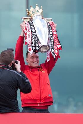 Phil Jones of Manchester United celebrates with the trophy - Manchester United - Premier League Trophy Parade - Manchester - England -13 05 2013 - EDITORIAL USE ONLY. No use with unauthorised audio, video, data, fixture lists, club league logos or live services. Online in-match use limited to 120 images, no video emulation. No use in betting, games or single club league player publications.