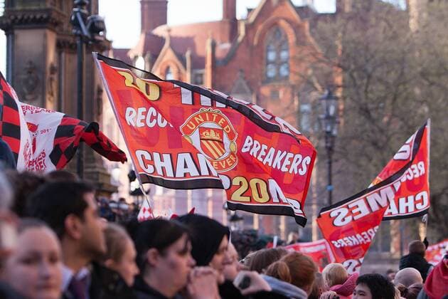 A fan flies a flag - Manchester United - Premier League Trophy Parade - Manchester - England -13 05 2013 - EDITORIAL USE ONLY. No use with unauthorised audio, video, data, fixture lists, club league logos or live services. Online in-match use limited to 120 images, no video emulation. No use in betting, games or single club league player publications.