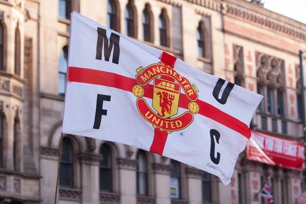 A fan flies a flag - Manchester United - Premier League Trophy Parade - Manchester - England -13 05 2013 - EDITORIAL USE ONLY. No use with unauthorised audio, video, data, fixture lists, club league logos or live services. Online in-match use limited to 120 images, no video emulation. No use in betting, games or single club league player publications.