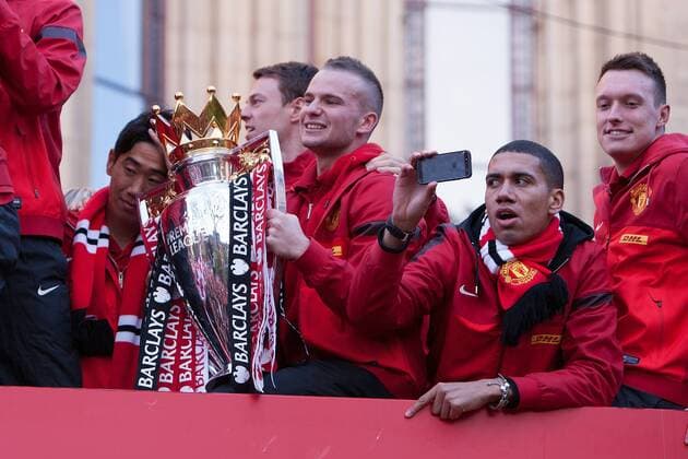 Tom Cleverley and Chris Smalling of Manchester United with the trophy - Manchester United - Premier League Trophy Parade - Manchester - England -13 05 2013 - EDITORIAL USE ONLY. No use with unauthorised audio, video, data, fixture lists, club league logos or live services. Online in-match use limited to 120 images, no video emulation. No use in betting, games or single club league player publications.