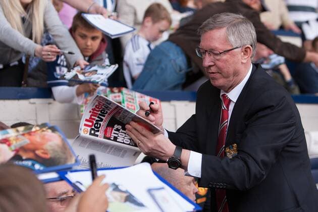 Football - 2012 2013 Premier League - West Bromwich Albion vs. Manchester United Alex Ferguson, manager of Manchester United signs autographs for fans at the Hawthorns 