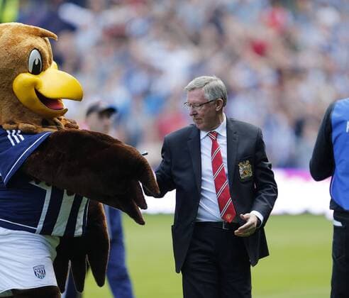 Manchester United s Sir Alex Ferguson receives a parting gift of a pack of chewing gum from West Brom s mascot - Barclays Premier League - West Bromwich Albion vs Manchester United - The Hawthrowns - West Bromwich - 19 05 2013 - Pic David Klein Sportimage EDITORIAL USE ONLY. No use with unauthorised audio, video, data, fixture lists, club league logos or live services. Online in-match use limited to 120 images, no video emulation. No use in betting, games or single club league player publications.