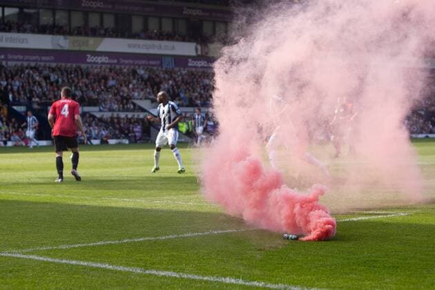 Football - 2012 2013 Premier League - West Bromwich Albion vs. Manchester United A red flare is thrown on to the pitch during play at the Hawthorns 
