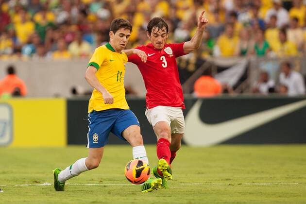 Football - International Friendly - Brazil vs. England Leighton Baines of England challenges Oscar of Brazil at the Maracana Stadium, Rio de Janeiro 