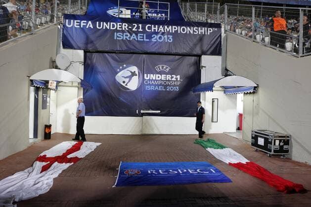 England s and Italy s flags are put out before the teams come out - England U21 vs Italy U21 - UEFA U21 Championship 2013 - Bloomfield Stadium - Tel Aviv - 05 06 2013 - EDITORIAL USE ONLY. No use with unauthorised audio, video, data, fixture lists, club league logos or live services. Online in-match use limited to 120 images, no video emulation. No use in betting, games or single club league player publications.