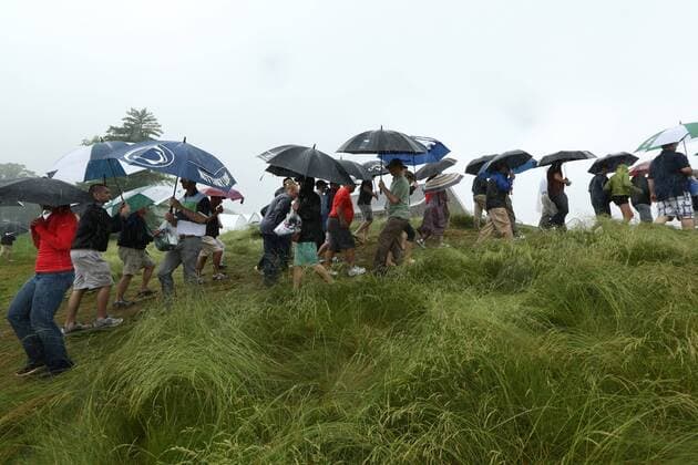 June 10 2013: Droves of fans with umbrellas walk over a path through the thicket to get out of the driving rain during monday s practice round at the 2013 U.S. Open hosted by Merion Golf Club in Ardmore, PA. GOLF: JUN 10 PGA Golf Herren - U.S. Open - Monday Practice Round Icon131833 EDITORIAL USE ONLY