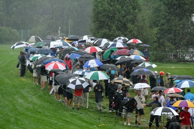 June 10, 2013 - Ardmore, PA, USA - Gallery members try to stay dry along the 7th hole during a practice round for the U.S. Open on Monday, June 10, 2013, At Meriod Golf Club in Ardmore, Pennsylvania. U.S. OPEN PRACTICE ROUNDS - ZUMAm67