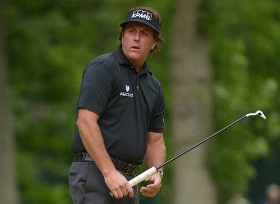 Phil Mickelson reacts after missing a putt on the 11th green during the first round of the 113th U.S. Open Championship at Merion Golf Club in Ardmore, Pennsylvania on June 12, 2013.  PHI20130613311