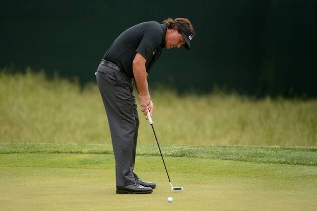 Phil Mickelson putts on the 13th green during the first round of the 113th U.S. Open Championship at Merion Golf Club in Ardmore, Pennsylvania on June 12, 2013.  PHI20130613316
