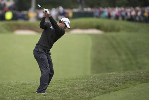 Adam Scott hits on the 18th fairway during the continuation of the first round of the 113th U.S. Open Championship at Merion Golf Club in Ardmore, Pennsylvania on June 14, 2013.  PHI20130614301