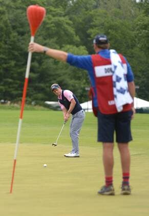 Luke Donald putts with the help of his caddie Gareth Lord on the 14th green during the second round 113th U.S. Open Championship at Merion Golf Club in Ardmore, Pennsylvania on June 14, 2013.  PHI20130614311