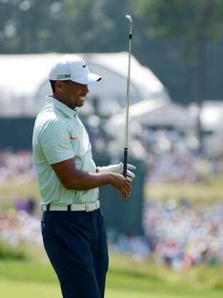Tiger Woods reacts after hitting an iron on the third hole in the third round at the 113th U.S. Open at Merion Golf Club in Ardmore, Pennsylvania on June 15, 2013.  PHI20130615103