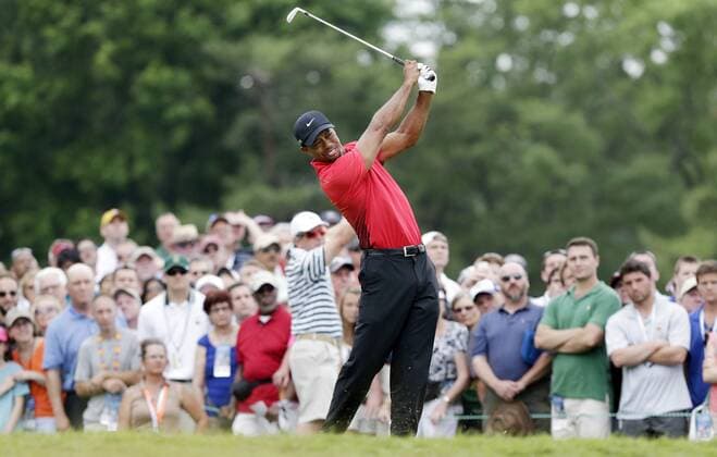 Tiger Woods hits an iron on the 9th tee box in the Final Round at the 113th U.S. Open at Merion Golf Club in Ardmore, Pennsylvania on June 16, 2013.  PHI20130616102