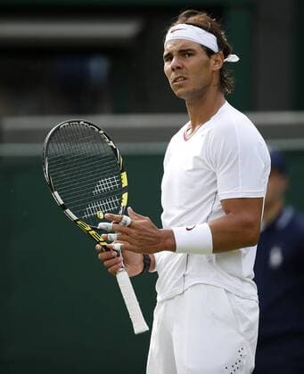 Rafael Nadal of Spain reacts during the first round of the men s singles at the Wimbledon Lawn Tennis Championships in the All England Lawn Tennis and Croquet Club in London, Britain, on June 24, 2013. (Xinhua Wang Lili) (SP)BRITAIN-LONDON-TENNIS-WIMBLEDON 