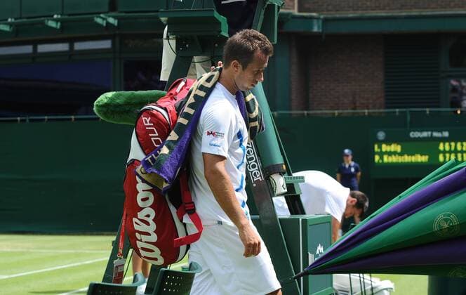 Tennis - 2013 Wimbledon Championships - Mens Singles First Round on Court 18. Philipp Kohlschreiber - Germany leaves the court after retiring in the 5th set 