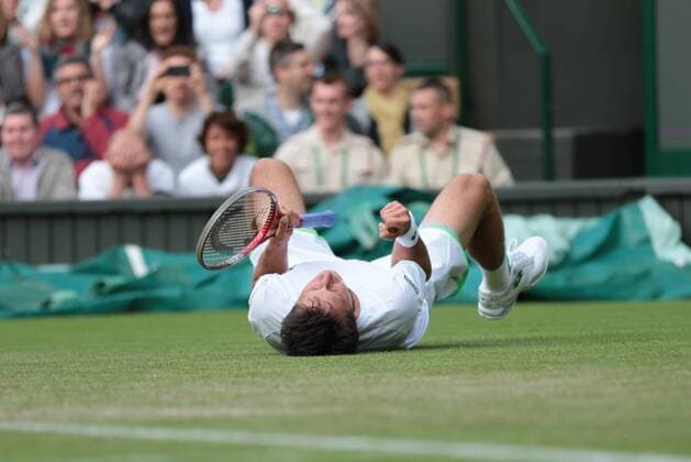 Ukranian Sergiy Stakhovsky celebrates on day three of the 2013 Wimbledon Championships in London on June 26, 2013.  LON2013062623