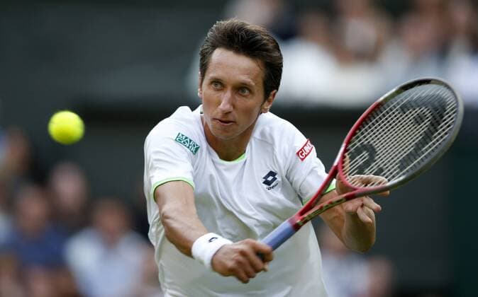 Sergiy Stakhovsky of Ukraine returns a shot during the second round of the men s singles on day 3 of the Wimbledon Lawn Tennis Championships at the All England Lawn Tennis and Croquet Club in London, Britain, on June 26, 2013. (Xinhua Wang Lili) (SP)BRITAIN-LONDON-TENNIS-WIMBLEDON-DAY 3 