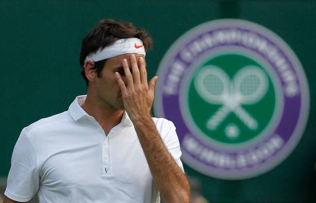 Roger Federer of Switzerland reacts during the second round of men s singles on day 3 of the Wimbledon Lawn Tennis Championships at the All England Lawn Tennis and Croquet Club in London, Britain, on June 26, 2013. (Xinhua Yin Gang) (SP)BRITAIN-LONDON-TENNIS-WIMBLEDON-DAY 3 