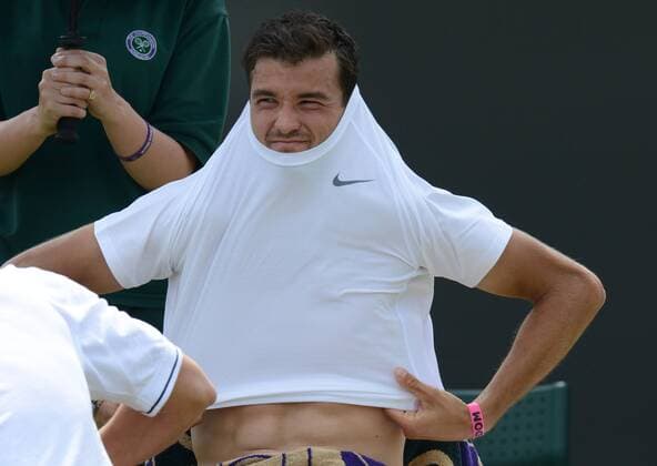 Tennis - 2013 Wimbledon Championships - Mens Singles second Round Grigor Dimitrov - Bulgaria squeezes into a new shirt 