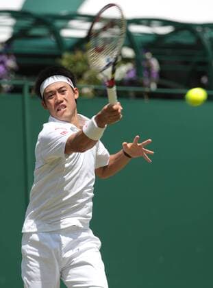 Japan s Kei Nishikori returns the ball his match on day six of the 2013 Wimbledon Championships in London on June 29, 2013.  LON2013062913