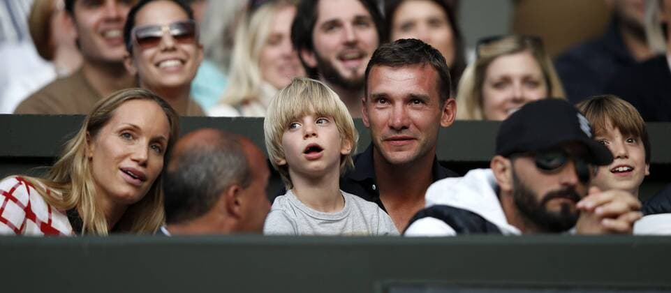 LONDON, June 29, 2013 -- Andriy Shevchenko (C), a retired Ukrainian footballer and a current Ukrainian politician, sits with his wife Kristen Pazik (L) and son to watch the the third round of gentlemen s singles on day 6 of the Wimbledon Lawn Tennis Championships at the All England Lawn Tennis and Croquet Club in London, Britain on June 29, 2013. 