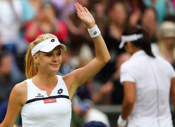 LONDON, July 2, 2013 -- Agnieszka Radwanska (L) of Poland reacts after the quarterfinal of women s singles on day 8 of the Wimbledon Lawn Tennis Championships at the All England Lawn Tennis and Croquet Club in London, Britain on July 2, 2013. 