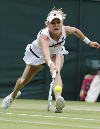 LONDON, July 2, 2013 -- Agnieszka Radwanska of Poland returns the ball during the quarterfinal of women s singles on day 8 of the Wimbledon Lawn Tennis Championships at the All England Lawn Tennis and Croquet Club in London, Britain on July 2, 2013. 