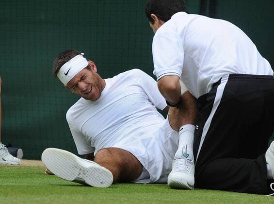 Tennis - 2013 Wimbledon Championships - Mens 1 4 Final - Juan Martin Del Potro (Arg) Feels the pain after taking heavy fall at the start of the match 