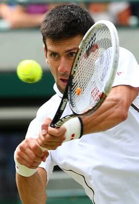 (130703) -- LONDON, July 3, 2013 (Xinhua) -- Novak Djokovic of Serbia hits a return during the quarterfinal of men s singles on day 9 of the Wimbledon Lawn Tennis Championships at the All England Lawn Tennis and Croquet Club in London, Britain, on July 3, 2013. (Xinhua Yin Gang) (jyc) (SP)BRITAIN-LONDON-TENNIS-WIMBLEDON-DAY 9 