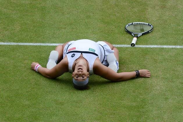 Tennis - 2013 Wimbledon Championships - Ladies Semi Final, Marion Bartoli (France) sinks to her knees after winning her semi Final 