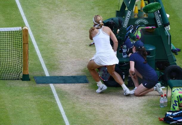 Tennis - 2013 Wimbledon Championships - Ladies Semi Final: Sabine Lisicki - Germany tries to avoid colliding with a Ball boy 
