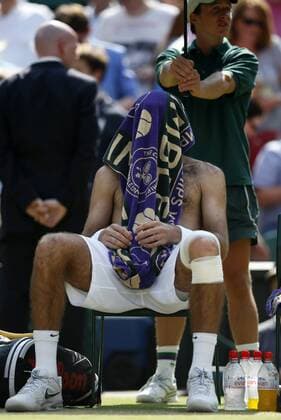 Juan Martin Del Potro of Argentina reacts during the semifinal of gentlemen s singles on day 11 of the Wimbledon Lawn Tennis Championships at the All England Lawn Tennis and Croquet Club in London, Britain on July 5, 2013. (Xinhua Wang Lili) (SP)BRITAIN-LONDON-TENNIS-WIMBLEDON-DAY 11 