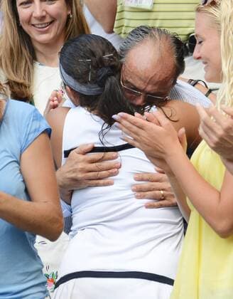 Tennis - 2013 Wimbledon Championships - Womens Final Marion Bartoli climbs up into the stand to hug her Father 