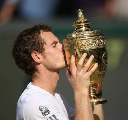 Andy Murray kisses the Wimbledon trophy after beating Novak Djokovic in the final of the 2013 Wimbledon Championships in London on July 7 , 2013. Murray won 6-4 7-5 6-4.  LON2013070701