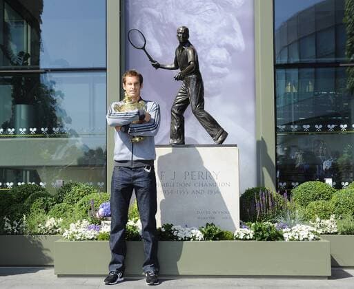 Andy Murray of Great Britain poses with the Gentlemen s Singles Trophy next to the Fred Perry statue at Wimbledon London, United Kingdom, Monday July 08, 2013. Photo by: Roger Allen i-Images RogerxAllenx xi-Images  SLK