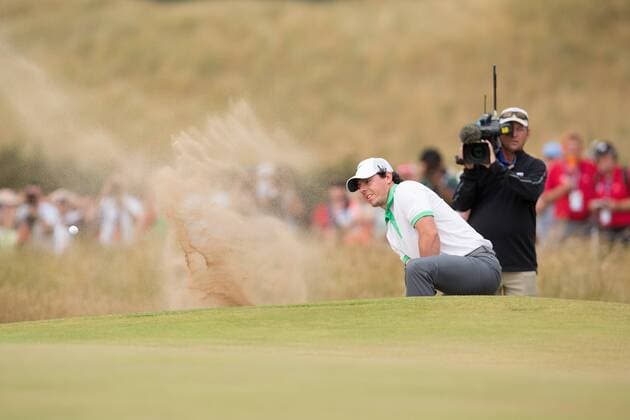 Golf - 2013 Open Championship at Muirfield - Thursday Round One Rory McIlroy of Northern Ireland struggles in a bunker on the 5th 