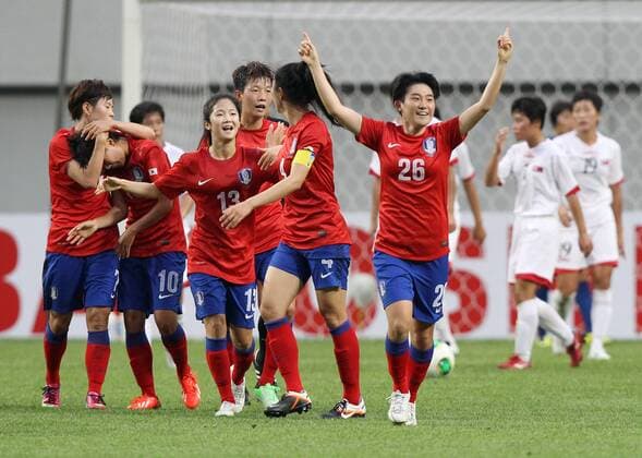 (130721) SEOUL, July 21, 2013. (Xinhua) -- Kim Soo-yun (front R) of South Korea national football team celebrates after scoring a goal against Democratic People s Republic of Korea (DPRK) national football team during the EAFF Women s Asian Cup 2013 match at the Seoul World Cup Stadium in Seoul, South Korea, July 21, 2013. DPRK won the match 2-1. (Xinhua Park Jin hee) (SP)SOUTH KOREA-SEOUL-SOCCER-EAFF WOMEN S EAST ASIAN CUP 2013-DPRK VS SOUTH KOREA 