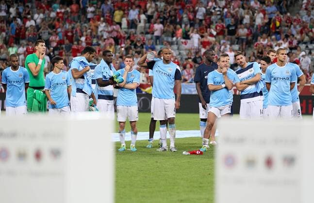Manchester City s Vincent Kompany looks on dejected at the final whistleholding his runners up trophy Bayern Munich v Manchester City - Audi Cup - Allianz Arena - Munich - Germany -01 08 2013 - EDITORIAL USE ONLY. No use with unauthorised audio, video, data, fixture lists, club league logos or live services. Online in-match use limited to 120 images, no video emulation. No use in betting, games or single club league player publications.